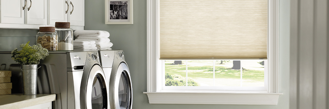 Beige roller shade inside a laundry room