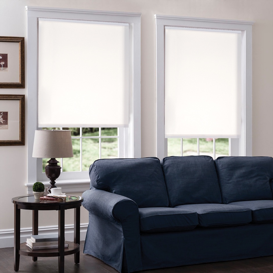 Roller shades behind a couch