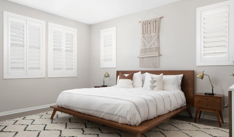Open shutter louvers will help any Fort Lauderdale room feel larger. Plantation shutters in a model home bedroom.