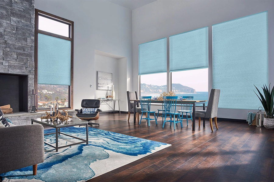 Smart motorized window shades are perfect on tall windows in your Fort Lauderdale home. Blue motorized shades on tall living room windows